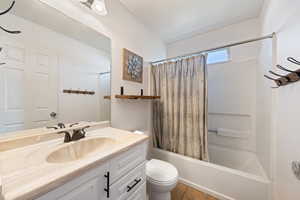 Bathroom featuring tile patterned floors, vanity, toilet, and shower / bath combo