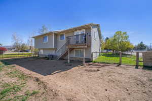 Rear view of house featuring a deck, stairs, fence, and central AC