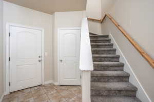 Stairway featuring baseboards