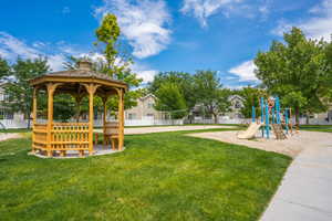 Community jungle gym featuring a yard, a gazebo, and fence