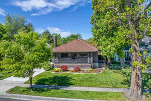 View of front of home featuring a porch, a front yard