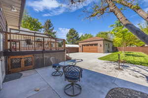 View of patio, and a detached garage