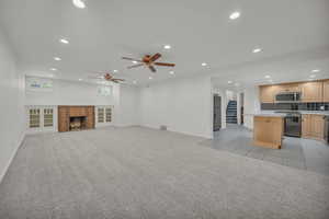 Unfurnished living room open to the kitchen