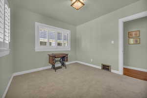 Carpeted bedroom with closet