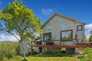 Rear view of property featuring a wooden deck