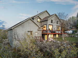 Rear view of property featuring a wooden deck