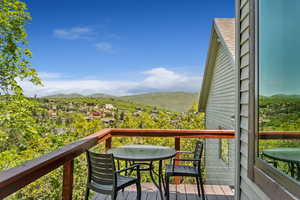 Balcony with a mountain view and outdoor dining space