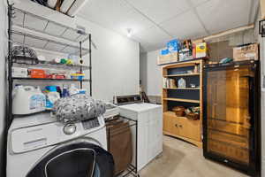 Clothes washing area featuring washer and clothes dryer and laundry area