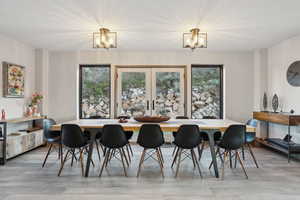 Dining space featuring an inviting chandelier and light wood-style floors