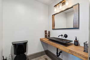 Bathroom featuring baseboards, visible vents, and a sink