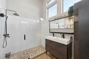 Full bathroom featuring a shower stall and vanity