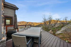 Deck featuring outdoor dining area and a mountain view
