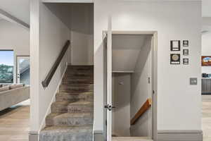 Stairs featuring baseboards and wood finished floors