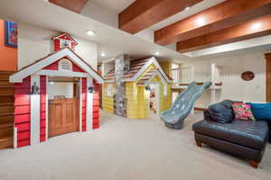 Recreation room with recessed lighting, beam ceiling, decorative columns, and carpet