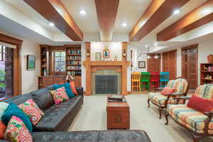 Living room with recessed lighting and a fireplace with flush hearth