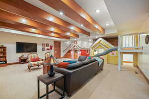 Carpeted living room featuring baseboards, stairs, recessed lighting, and visible vents
