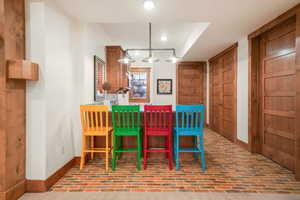 Dining space with baseboards, brick patterned floor, and recessed lighting