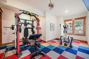 Workout room featuring baseboards, tile patterned floors, and recessed lighting
