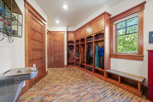 Mudroom with brick floor and recessed lighting