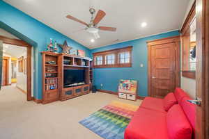 Carpeted living room featuring baseboards, recessed lighting, and a ceiling fan