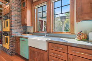 Kitchen featuring brown cabinetry, a healthy amount of sunlight, and a sink