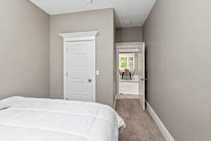 Carpeted bedroom featuring visible vents and baseboards