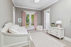 Bedroom featuring french doors, carpet, visible vents, crown molding, and access to outside