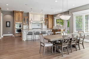 Dining area featuring baseboards, light wood-type flooring, and recessed lighting