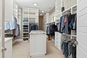 Walk in closet featuring light colored carpet and visible vents
