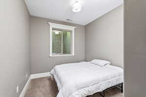 Bedroom featuring baseboards, visible vents, and carpet floors
