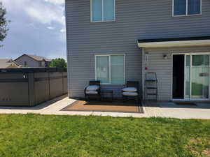 Back of house featuring a patio and a lawn