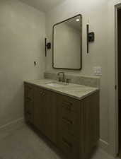 Bathroom with vanity and baseboards