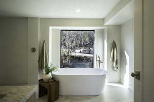 Full bath with a soaking tub and recessed lighting