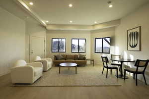 Living room featuring wood finished floors, baseboards, and recessed lighting