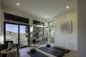 Workout room featuring baseboards, recessed lighting, and wood finished floors