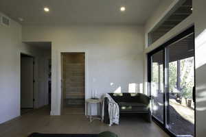 Living room with visible vents, wood finished floors, baseboards, and recessed lighting