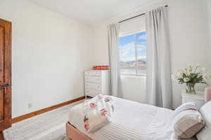 Bedroom featuring a water view and baseboards