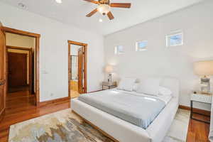 Bedroom featuring connected bathroom, wood finished floors, baseboards, and recessed lighting