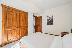Carpeted bedroom featuring baseboards