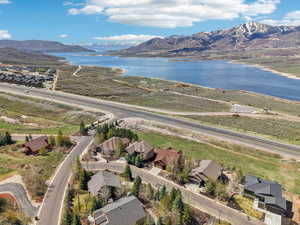 Birds eye view of property with a water and mountain view and a residential view