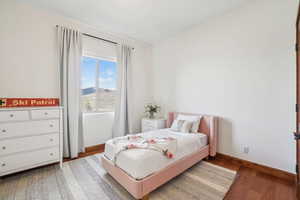 Bedroom with baseboards and wood finished floors