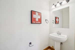 Bathroom featuring a sink and baseboards