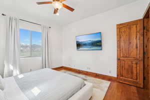 Bedroom with baseboards, a ceiling fan, and wood finished floors