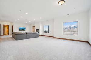 Living room featuring light colored carpet, baseboards, and recessed lighting