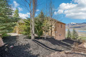 View of side of property featuring fence and a water and mountain view