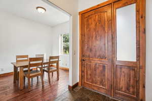Dining space with baseboards, dark wood-style floors, and visible vents