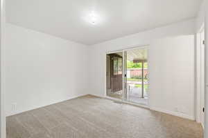 Empty room featuring visible vents, baseboards, and carpet floors