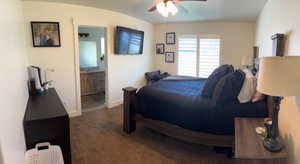 Bedroom with carpet floors, ceiling fan, baseboards, and ensuite bath