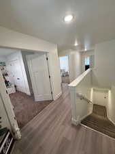 Interior space with baseboards, a textured ceiling, and wood finished floors