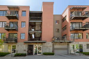 View of building exterior with driveway and an attached garage